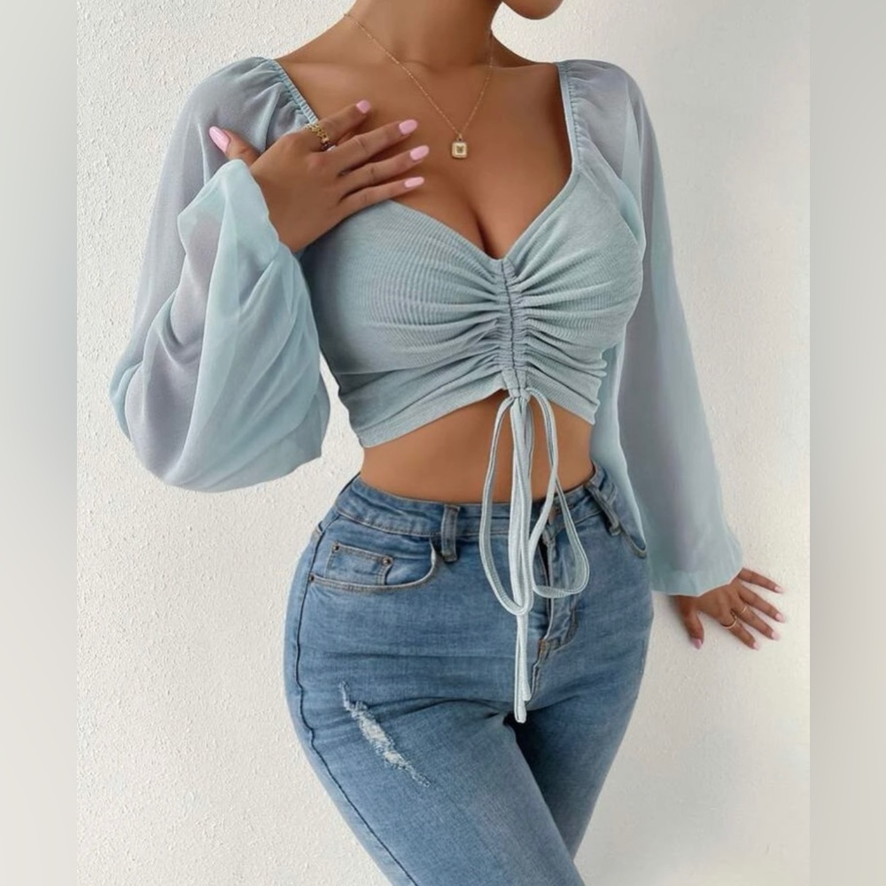 Light blue crop top with flowey sleeves. Never worn